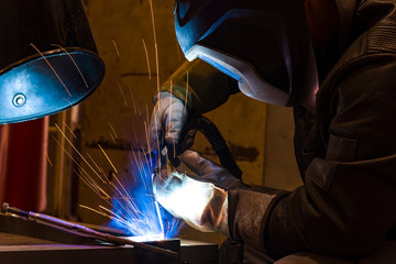 Industrial steel welder in factory welder, craftsman