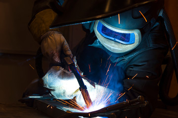 Industrial steel welder in factory welder, craftsman