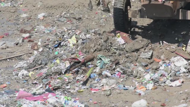 Group of asian people cleaning up the beach with plastic bags full of garbage. People with environment and volunteering concept.