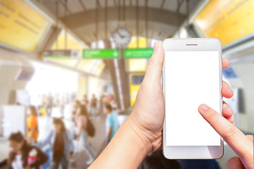 Female use hand holding smartphone with empty screen blurred images touch of Abstract blur in the BTS Skytrain Station at Bangkok, Thailand,the big city travel lifestyle transportation concept