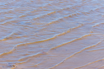 waves in the water on the sand