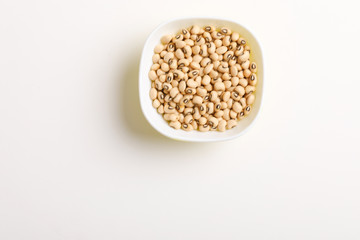 Black eyed seeds or chawali seeds in glass bowl on white background 