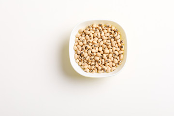 Black eyed seeds or chawali seeds in glass bowl on white background 