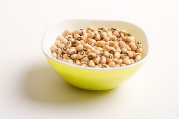 Black eyed seeds or chawali seeds in glass bowl on white background 