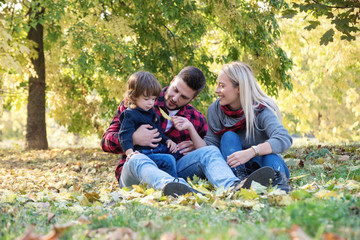 Fototapeta premium Young happy family spending time together outdoors