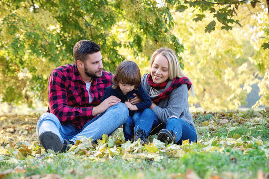 Young happy family spending time together outdoors