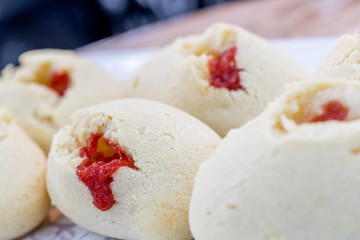 Colombian pandebono with arequipe on wooden board