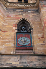 Ancient clock on a church in Colmar, France