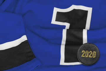 Fragment of a blue hockey sweater with a puck