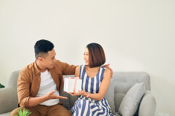 Portrait of young Asian giving a present box for his girlfriend