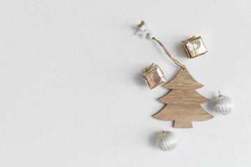 natural wood craft Christmas with golden gift box and silver white ball on cement wall greeting minimalism background