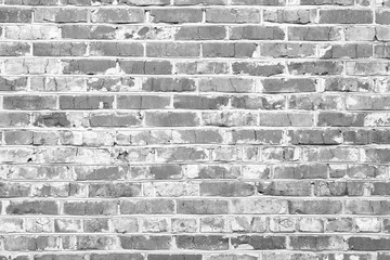 Black and white photo with image of brick wall made of old bricks with different textures