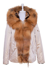 Fur clothes isolated. A stylish and luxurious bright female winter jacket with fur hood and large collar on mannequin isolated on a white background. Winter fashion.