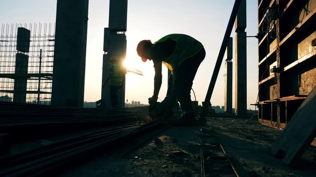 Building site with an engineer welding metal stems