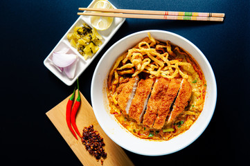 Khao Soi Chicken, a Thai food that is widely popular in the north along with the side dishes. With crispy fried chicken on top