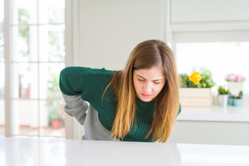 Obraz na płótnie Canvas Young beautiful plus size woman wearing casual striped sweater Suffering of backache, touching back with hand, muscular pain