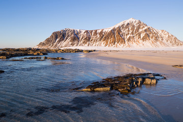 Evening mood at beautiful beach on Lofoten islands in winter