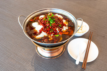 Sichuan spicy boiled fish hot pot with red hot spicy chilli. Asia China Chongqing Chengdu food.