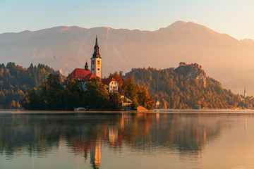Fototapeta na wymiar Lake bled with island bled in slovenia on early morning with morning fog on the water surface