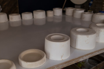 ceramic cast ,molds for cup on the table in the workshop.