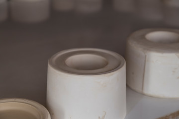 ceramic cast ,molds for cup on the table in the workshop.