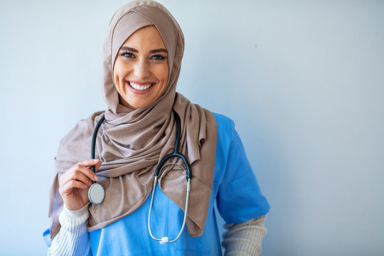 Confident female nurse. Confident Muslim female doctor standing with isolated gray. Closeup portrait of friendly, smiling confident muslim female doctor. Portrait of Muslim nurse with stethoscope