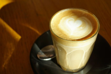 cup of coffee latte on wooden table