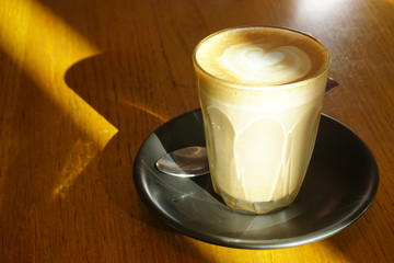 cup of coffee latte on wooden table