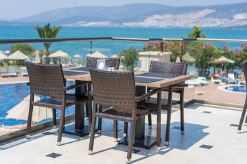 Table and chairs in restaurant , Turkey. Beach cafe near sea, outdoors. Travel and vacation concept