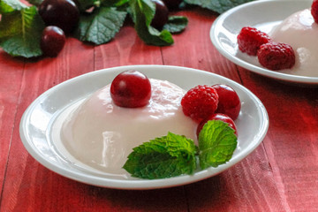 Panacota decorated with raspberries and mint