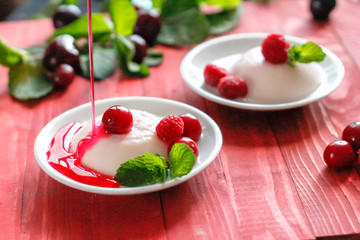 Panacota decorated with raspberries and mint