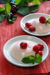 Panacota decorated with raspberries and mint