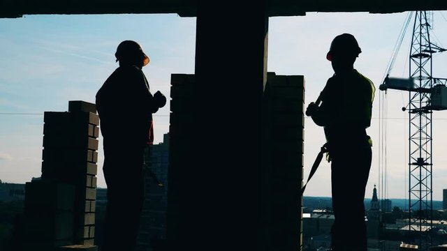 Workers are building a construction of bricks