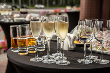 A buffet table on the terrace with glasses of champagne. Glasses of champagne stand on the terrace table.