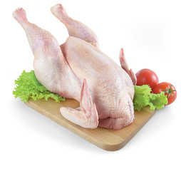 whole raw chicken with tomatoes - isolated