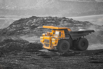 Open pit mine industry. Big yellow mining truck for coal moving on road career