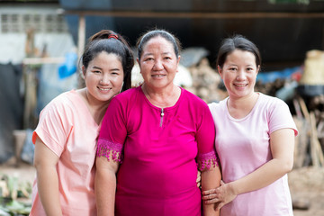 Group of three Asian women, Mother and her daughters standing by her
