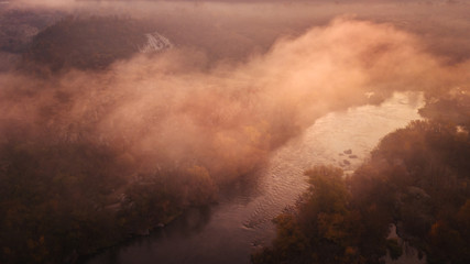 amazing aerial view on sunrise. foggy river and golden  trees. beautiful autumn landscape. drone shot, bird's eye