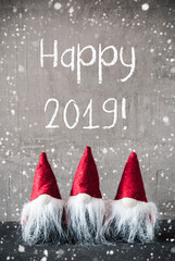 Three Gray Gnomes With English Text Happy 2019 And Red Jelly Bag Cap. Urban Cement Background With...