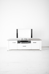 TV with white screen on a stand in the room.