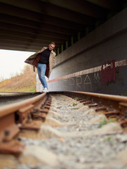 Autumn mood, young guy in a raincoat trench coat underground, street style.