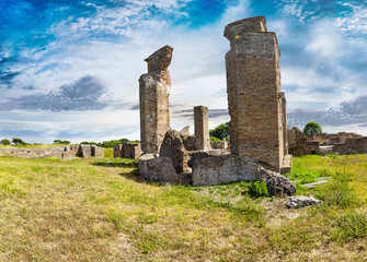 Panoramic view at archaeological excavations of Ostia Antica with beautiful scenery of the ruins of Marine Door thermal baths, Rome Italy