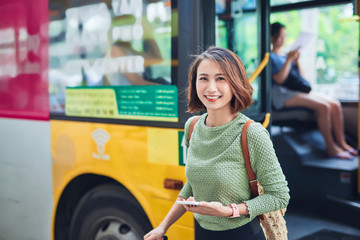 Female traveler going off the bus at terminal