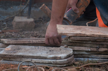 Worker cutting a tile using an angle grinder.Construction tool