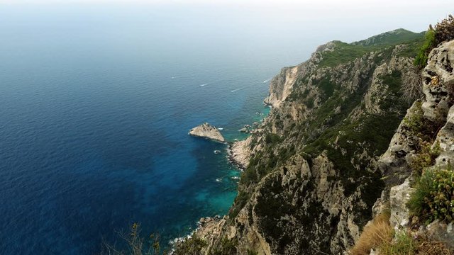 Landscape of mountain and blue sea. Rocky shore of the Mediterranean coast in Greece. 4K