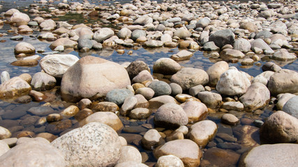 Stone on the lake after waterfall