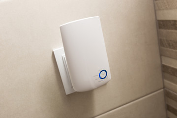 Wifi home repeater plugged in closeup.