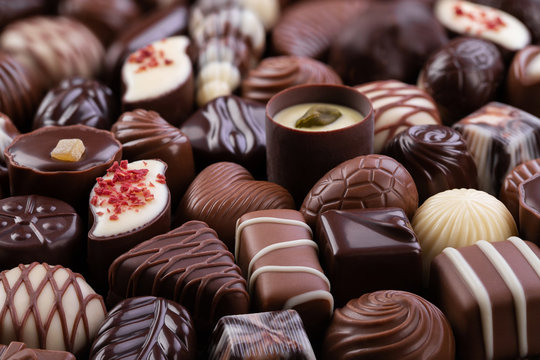 chocolate candy with various fillings, sweet food background.
