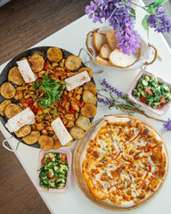 sac and pizza on the table top view