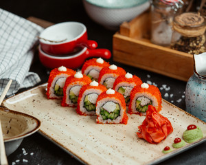 fresh sushi with red caviar on wooden board